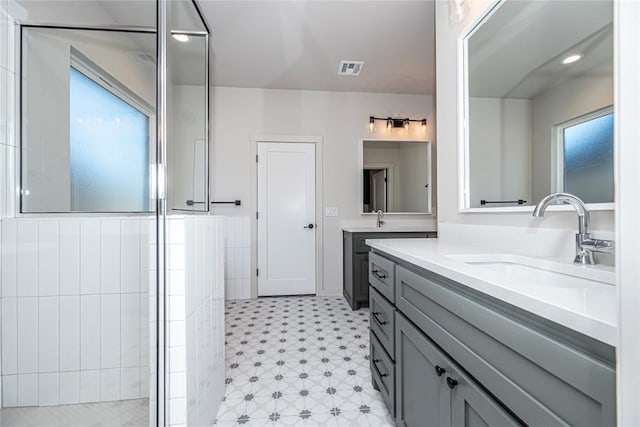 bathroom featuring walk in shower and vanity