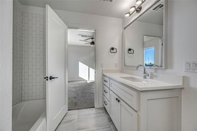 bathroom featuring ceiling fan, vanity, and washtub / shower combination