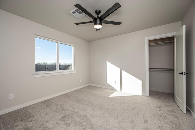 unfurnished bedroom with light carpet, ceiling fan, and a closet