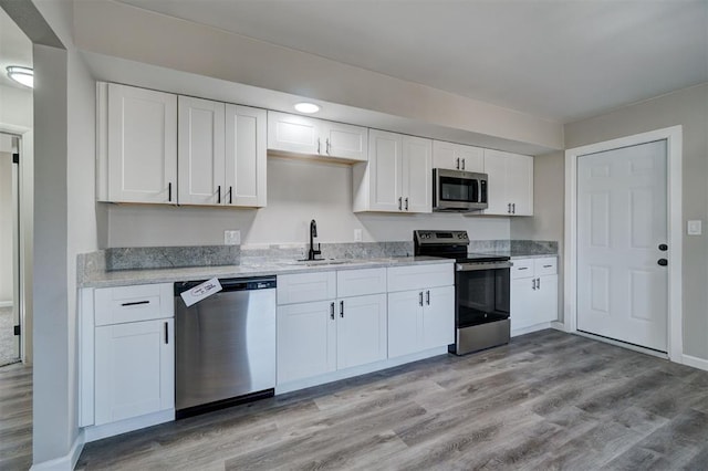 kitchen featuring white cabinetry, appliances with stainless steel finishes, and sink