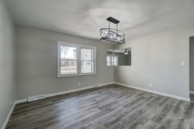 unfurnished dining area with ceiling fan and wood-type flooring