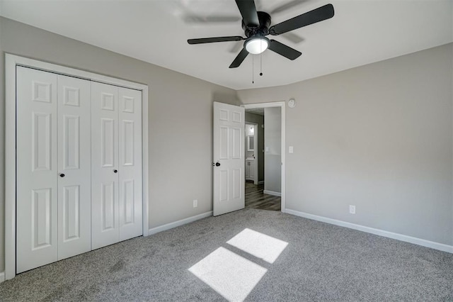 unfurnished bedroom with carpet flooring, ceiling fan, and a closet