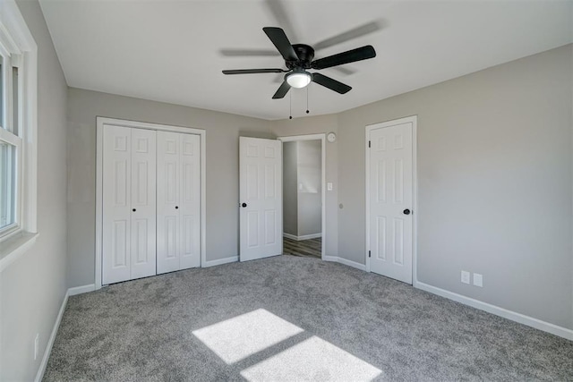 unfurnished bedroom featuring ceiling fan and carpet