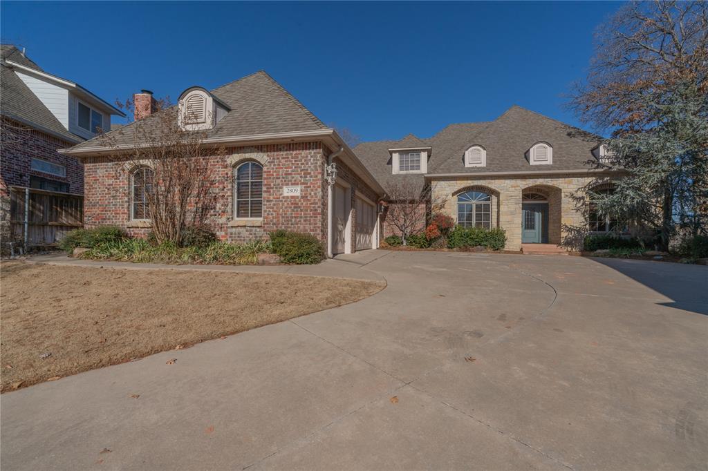 french country home with a garage