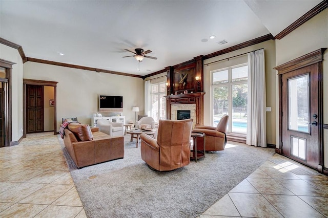 living room with ornamental molding, light carpet, and ceiling fan