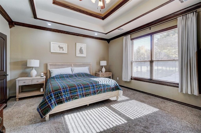 carpeted bedroom with a raised ceiling, crown molding, and ceiling fan