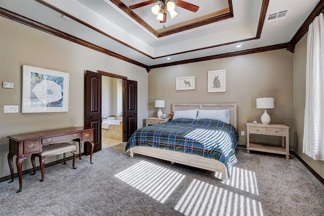 bedroom with crown molding, ceiling fan, connected bathroom, and a raised ceiling