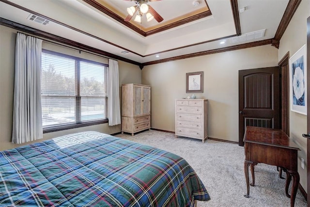 bedroom featuring a tray ceiling, ornamental molding, light colored carpet, and ceiling fan