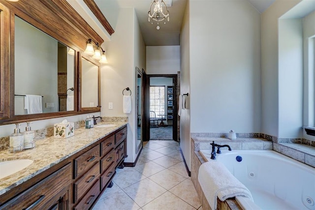 bathroom with a relaxing tiled tub, tile patterned floors, vanity, and a notable chandelier