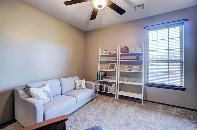 living area featuring ceiling fan and carpet floors