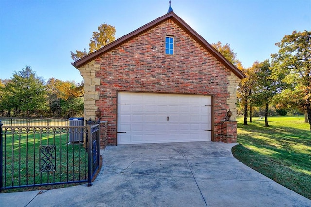 garage with a yard and central AC unit