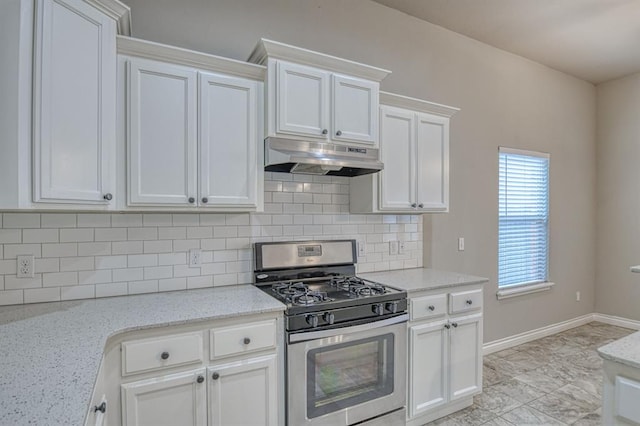 kitchen featuring white cabinets, decorative backsplash, light stone countertops, and stainless steel gas range