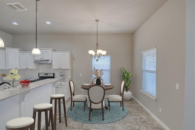 dining room with a notable chandelier