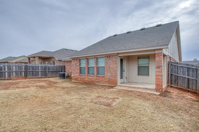 back of house featuring a patio area, a yard, and cooling unit