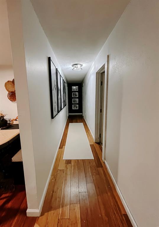 hallway with wood-type flooring