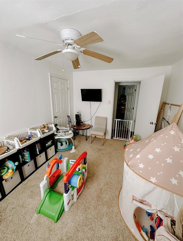 bedroom with ceiling fan and light colored carpet