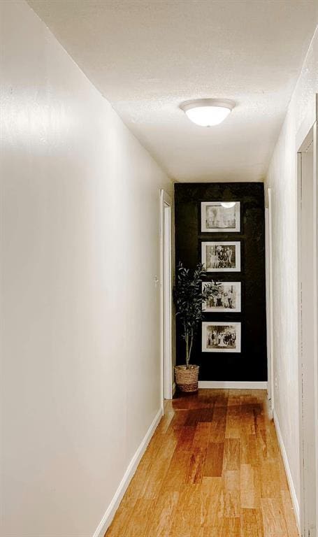 corridor with wood-type flooring