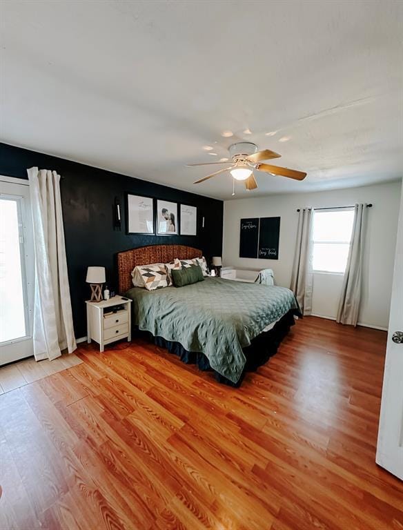 bedroom with ceiling fan and light hardwood / wood-style flooring