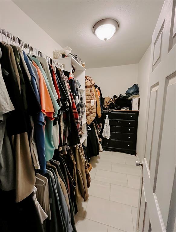 spacious closet with light tile patterned flooring