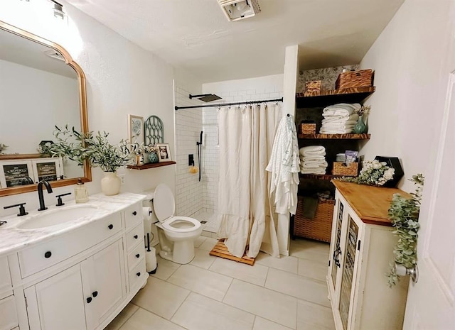 bathroom with toilet, vanity, tile patterned flooring, and curtained shower