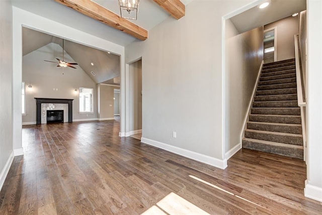 unfurnished living room with high vaulted ceiling, wood-type flooring, beamed ceiling, and ceiling fan with notable chandelier