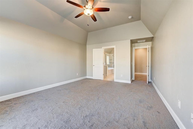 unfurnished bedroom with vaulted ceiling, ceiling fan, ensuite bathroom, and light carpet