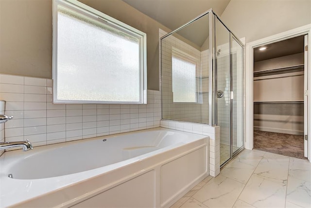 bathroom with a healthy amount of sunlight and plus walk in shower