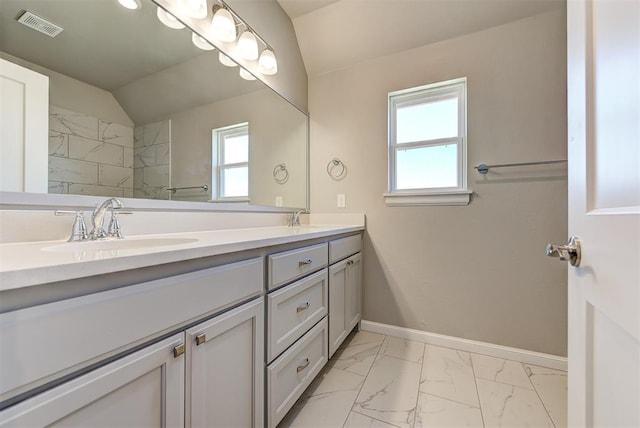 bathroom featuring vanity and lofted ceiling