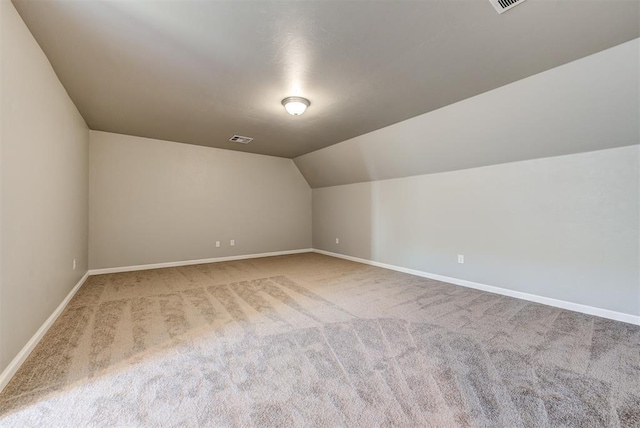 bonus room featuring vaulted ceiling and carpet floors