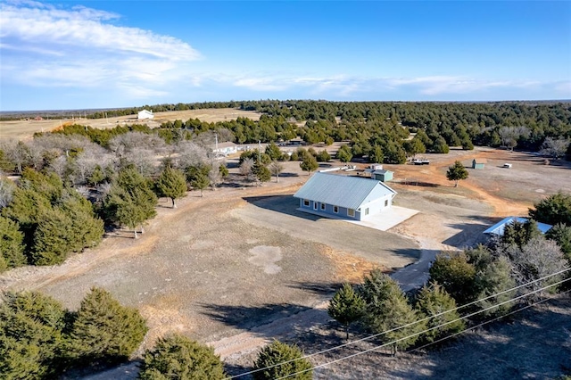 drone / aerial view featuring a forest view