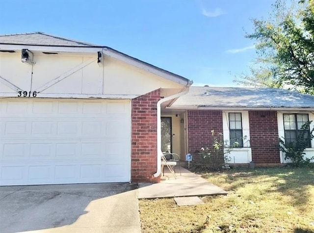 ranch-style house with a front yard and a garage