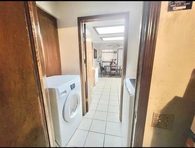 washroom with light tile patterned floors and washer and dryer