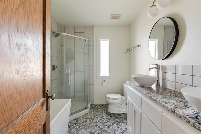 full bathroom featuring vanity, independent shower and bath, and toilet