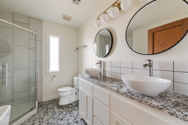 bathroom featuring tile walls, backsplash, an enclosed shower, vanity, and toilet