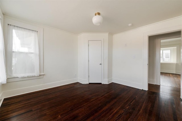 spare room featuring dark wood-type flooring