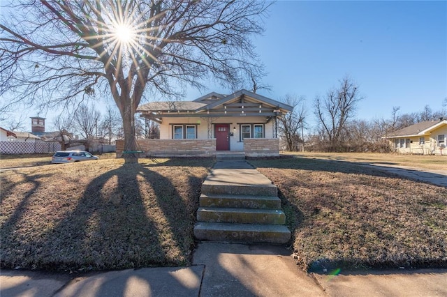 bungalow featuring a porch and fence