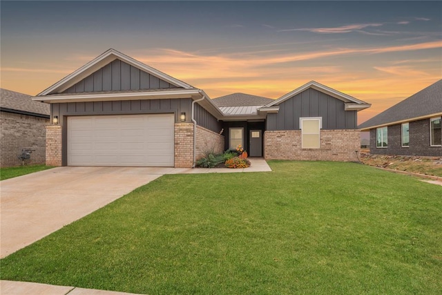 view of front of property featuring a garage and a lawn