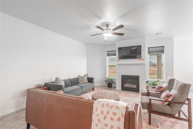 living room featuring ceiling fan and light wood-type flooring