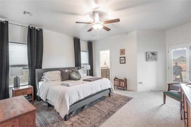 bedroom featuring ceiling fan, ensuite bathroom, and carpet floors