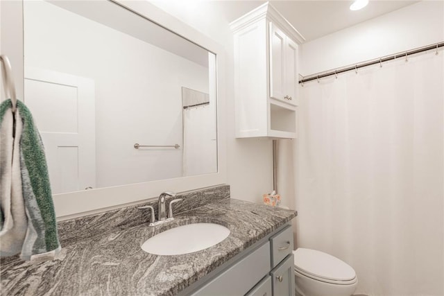 bathroom with toilet and vanity