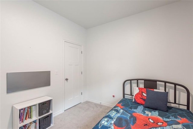 bedroom featuring light colored carpet