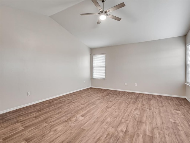 spare room featuring vaulted ceiling, ceiling fan, and light wood-type flooring