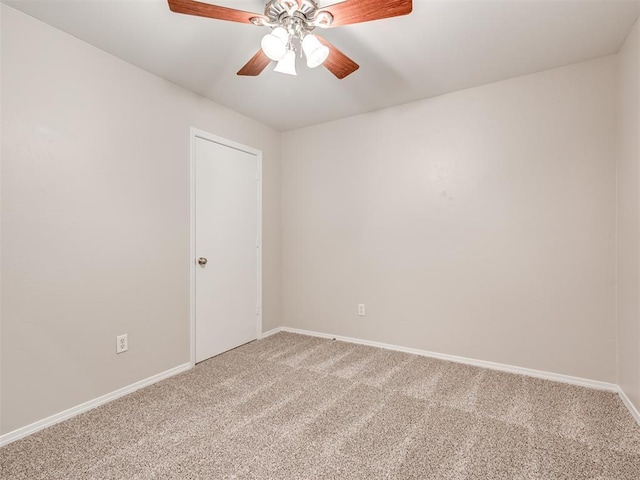 carpeted spare room with ceiling fan