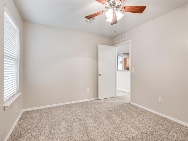 carpeted empty room with ceiling fan