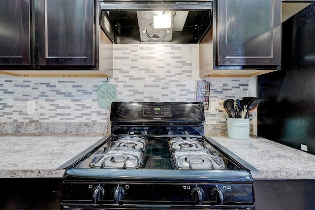 kitchen with decorative backsplash, black range with gas stovetop, dark brown cabinets, and exhaust hood