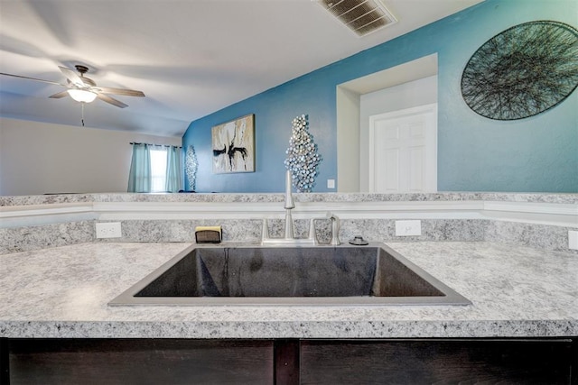 bathroom with ceiling fan and sink