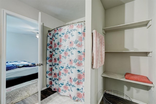 bathroom with hardwood / wood-style floors, ceiling fan, and a shower with curtain