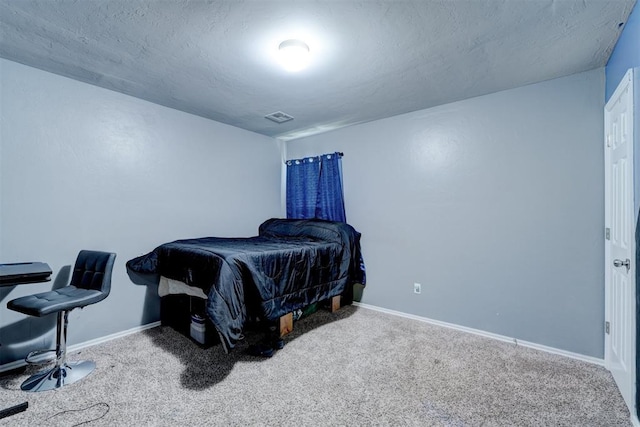 carpeted bedroom with a textured ceiling