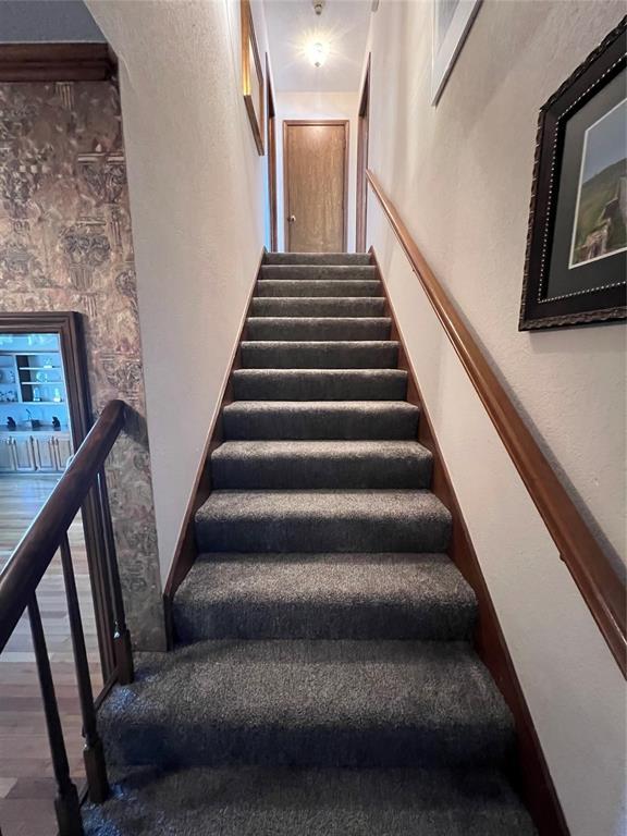 stairway featuring wood finished floors