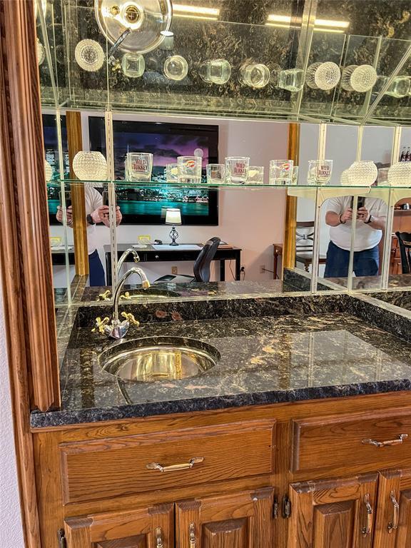 bar featuring indoor wet bar and a sink